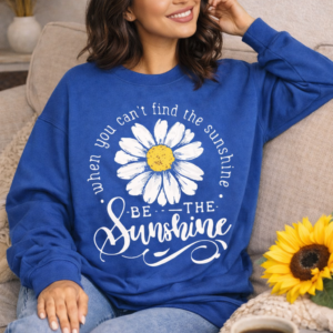 Blue sweatshirt with daisy graphic and be the sunshine phrase